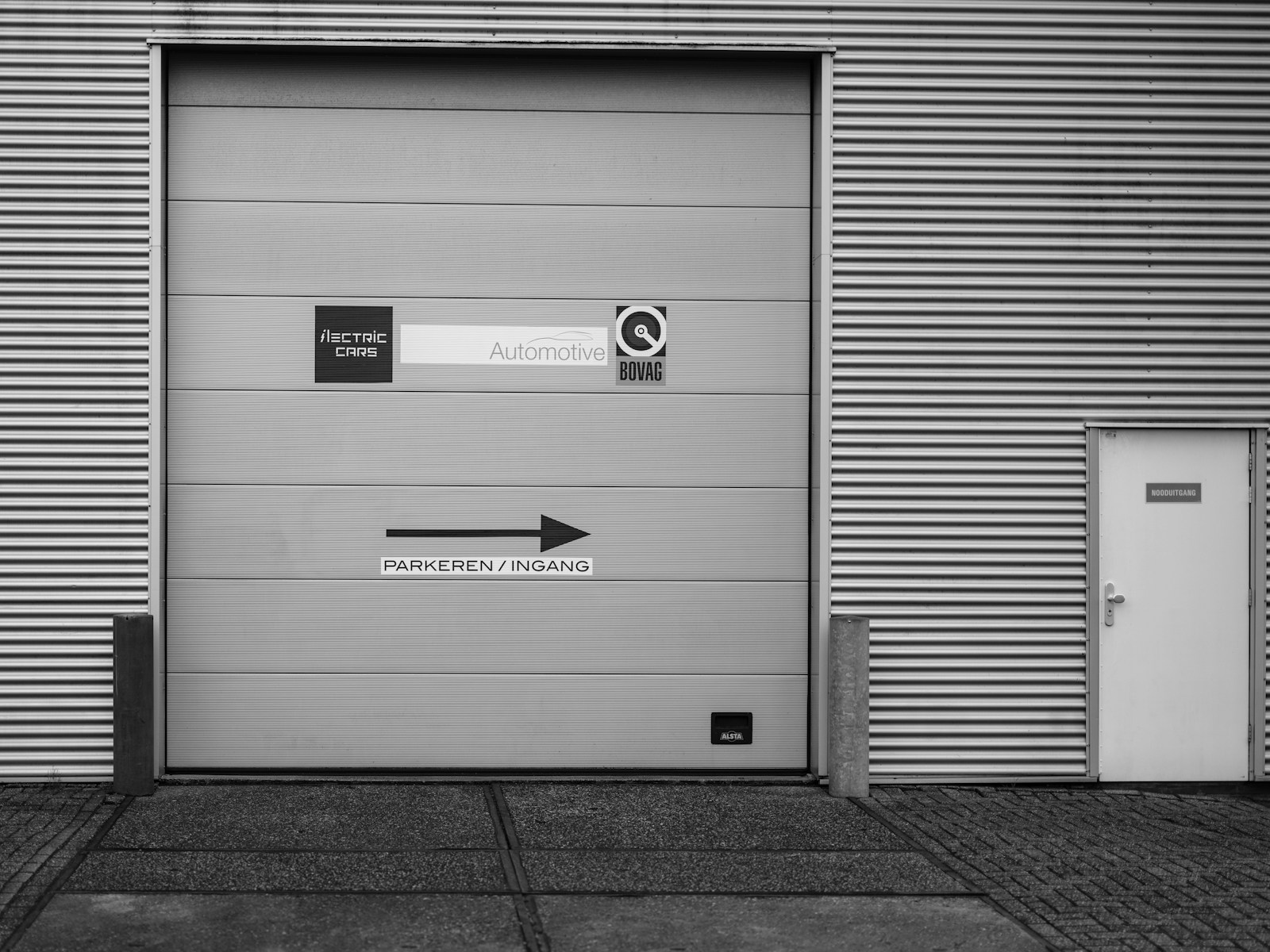 A black and white photo of a garage door